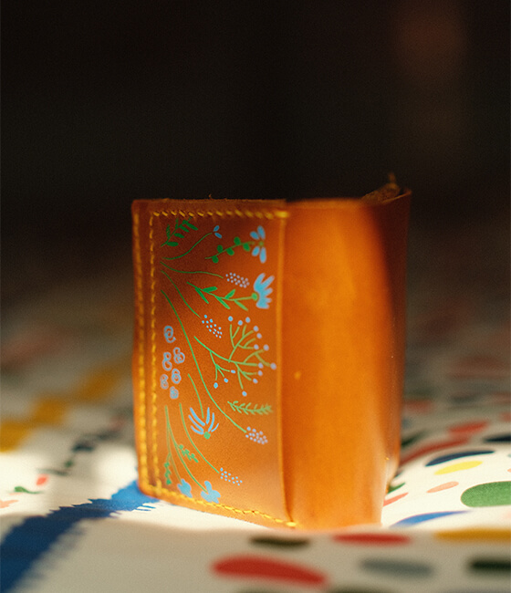 <h4><i>leather wallet</i></h4>
					<h4><b>March 2021</b></h4>
					<h4>I've been going on a lot more outdoor trips and starting to feel like my old wallet was getting too bulky. I tried my hand at making a wallet out of leather, this time one that can fit in my pocket! I decided to add a bit of a personal touch by painting some flowers on the front.</h4>