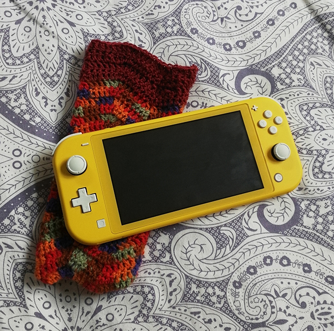 <h4><i>switch case</i></h4>
					<h4><b>April 2020</b></h4>
					<h4>I got a Nintendo Switch Lite and knew it needed a carrying case. Instead of buying one, I decided to crochet my own! I usually find crocheted squares somewhat plain and boring, so I took the chance to learn the ripple stitch in order to make the design a little more intricate! </h4>